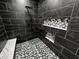 Modern shower featuring marble look tile, bench and hexagon tile floor at 2201 W Wisteria Way, Pahrump, NV 89048