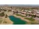 Aerial view of houses nestled beside a golf course with a pond and mountain views at 2317 Sierra Heights Dr, Las Vegas, NV 89134