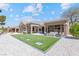 Rear exterior view with covered patio, inviting furniture, and impeccable backyard landscaping at 2317 Sierra Heights Dr, Las Vegas, NV 89134