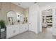 Well-lit bathroom featuring dual sinks, sleek lighting fixtures, and a view into the bedroom at 2317 Sierra Heights Dr, Las Vegas, NV 89134