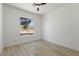 Minimalist bedroom with natural light, a ceiling fan, and views of the surrounding landscape at 2317 Sierra Heights Dr, Las Vegas, NV 89134