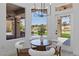 Cozy breakfast nook with golf course views, a modern chandelier, and access to the backyard at 2317 Sierra Heights Dr, Las Vegas, NV 89134