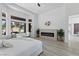 Comfortable main bedroom with a modern fireplace and seating area overlooking golf course at 2317 Sierra Heights Dr, Las Vegas, NV 89134