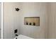 Modern tiled shower with a niche and sleek fixtures, offering a spa-like experience at 2317 Sierra Heights Dr, Las Vegas, NV 89134