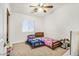 Cozy bedroom with two twin beds, a ceiling fan, and a window, perfect for  at 2509 April Breeze Ln, Henderson, NV 89002