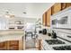 Bright, cheerful kitchen featuring tile floors and an adjacent living and dining area at 2509 April Breeze Ln, Henderson, NV 89002