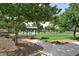 Lush park with walking paths, picnic tables under shaded canopies, and mature trees at 2509 April Breeze Ln, Henderson, NV 89002