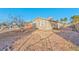Exterior backyard view featuring a gravel landscape, privacy fence, and palm trees at 2708 Bello Dr, North Las Vegas, NV 89030