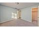 Well-lit bedroom showcasing neutral carpet, light blue walls, and a closet at 2708 Bello Dr, North Las Vegas, NV 89030