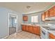 Functional kitchen with wooden cabinets, tile countertops and basic appliances at 2708 Bello Dr, North Las Vegas, NV 89030