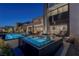 A modern backyard with a pool, spa, and ample space for entertaining and outdoor dining at 29 Falling Ridge Ln, Henderson, NV 89011