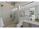 Modern bathroom featuring glass shower, sleek vanity, and a view of a small yard at 29 Falling Ridge Ln, Henderson, NV 89011
