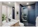 Modern bathroom with elegant blue tile, a glass-enclosed shower, and stylish fixtures at 29 Falling Ridge Ln, Henderson, NV 89011