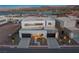 Stunning modern home with a two-car garage, desert landscaping, and partial lake views at 29 Falling Ridge Ln, Henderson, NV 89011