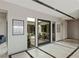 Modern foyer with tile flooring, stone accents, and a view of the courtyard with desert landscaping at 29 Falling Ridge Ln, Henderson, NV 89011