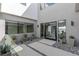 Modern home featuring a courtyard entrance with desert landscaping, clean lines, and ample natural light at 29 Falling Ridge Ln, Henderson, NV 89011