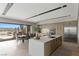 Open kitchen with an island, dining area, and outdoor access to a patio with scenic views at 29 Falling Ridge Ln, Henderson, NV 89011