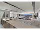 Modern kitchen with island seating and stainless steel appliances overlooks a spacious living area with scenic views at 29 Falling Ridge Ln, Henderson, NV 89011