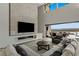 Living room with high ceilings, a fireplace, large windows, and an open floor plan at 29 Falling Ridge Ln, Henderson, NV 89011