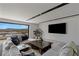 A modern living room with expansive views, comfortable seating, and a TV at 29 Falling Ridge Ln, Henderson, NV 89011