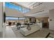 Elegant living room with large windows showcasing stunning views, open layout, and modern furnishings at 29 Falling Ridge Ln, Henderson, NV 89011