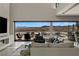 Open concept living space with views of the pool area and mountains beyond through expansive glass doors at 29 Falling Ridge Ln, Henderson, NV 89011