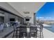 An outdoor dining area leading to a luxurious outdoor living space with lake views at 29 Falling Ridge Ln, Henderson, NV 89011