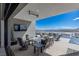 Relaxing outdoor patio featuring lounge furniture, a TV, and scenic views of the lake at 29 Falling Ridge Ln, Henderson, NV 89011