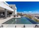 Beautiful pool area, outdoor kitchen, and lounge spaces for relaxing and entertaining at 29 Falling Ridge Ln, Henderson, NV 89011