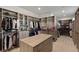 Spacious walk-in closet featuring custom organizers, shelves, and a center island for optimal storage at 29 Falling Ridge Ln, Henderson, NV 89011