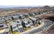 An aerial view of a community showcasing modern homes, desert landscaping, and mountain views at 302 Watteau Ct, Henderson, NV 89012