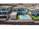 A desert modern home's backyard features a covered lounge area, pool, and desert landscaping at 302 Watteau Ct, Henderson, NV 89012
