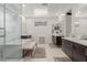Bright bathroom with a soaking tub, glass-enclosed shower, and dual vanity sinks at 302 Watteau Ct, Henderson, NV 89012