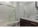 Modern bathroom featuring a walk-in shower, vanity with white countertop and brown cabinets at 302 Watteau Ct, Henderson, NV 89012