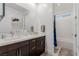 Bright bathroom with double sinks, bathtub and white subway tile at 302 Watteau Ct, Henderson, NV 89012