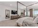 Spacious bedroom showcasing a four-poster bed, seating area, and beautiful views at 302 Watteau Ct, Henderson, NV 89012