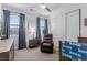 A bedroom with a window view offers a relaxing retreat with comfortable seating and storage space, designed for relaxation at 302 Watteau Ct, Henderson, NV 89012