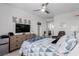 A cozy bedroom with a TV and a window view offers a relaxing retreat with ample storage and comfortable seating at 302 Watteau Ct, Henderson, NV 89012