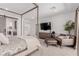 Bedroom with a four poster bed, lounge area, and modern dresser with mounted TV at 302 Watteau Ct, Henderson, NV 89012