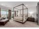 Spacious bedroom featuring a four-poster bed, private balcony, and stylish furniture at 302 Watteau Ct, Henderson, NV 89012