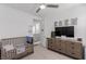 Charming bedroom featuring a wooden crib, modern dresser and ceiling fan at 302 Watteau Ct, Henderson, NV 89012