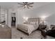 Elegant bedroom featuring a comfortable bed, ceiling fan and walk-in closet at 302 Watteau Ct, Henderson, NV 89012