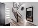 This modern entryway features wood floors, white walls, modern decorations and a staircase at 302 Watteau Ct, Henderson, NV 89012