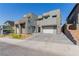 Modern gray multi-story home boasting a desert landscape, 2-car garage, and sleek design at 302 Watteau Ct, Henderson, NV 89012