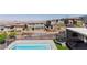 A modern two-story home with a pool and backyard, complemented by desert views and landscaping for privacy and beauty at 302 Watteau Ct, Henderson, NV 89012