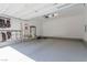 Clean and spacious three car garage featuring a durable epoxy floor and ample storage space at 302 Watteau Ct, Henderson, NV 89012