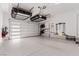Attached garage with epoxy floors, overhead storage and a garage door with windows at 302 Watteau Ct, Henderson, NV 89012