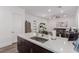 Bright, open kitchen with stainless appliances, white countertops, and views to other rooms of the house at 302 Watteau Ct, Henderson, NV 89012