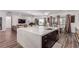 Open kitchen features a large island with marble countertops and stainless steel appliances at 302 Watteau Ct, Henderson, NV 89012