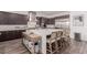 Modern kitchen featuring a large island with seating and stainless steel appliances at 302 Watteau Ct, Henderson, NV 89012